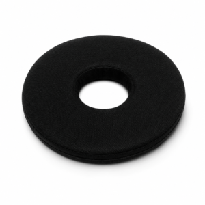 Black donut-shaped cushion with a hollow center, likely a travel neck pillow design? Noting the fabric texture and circular form.